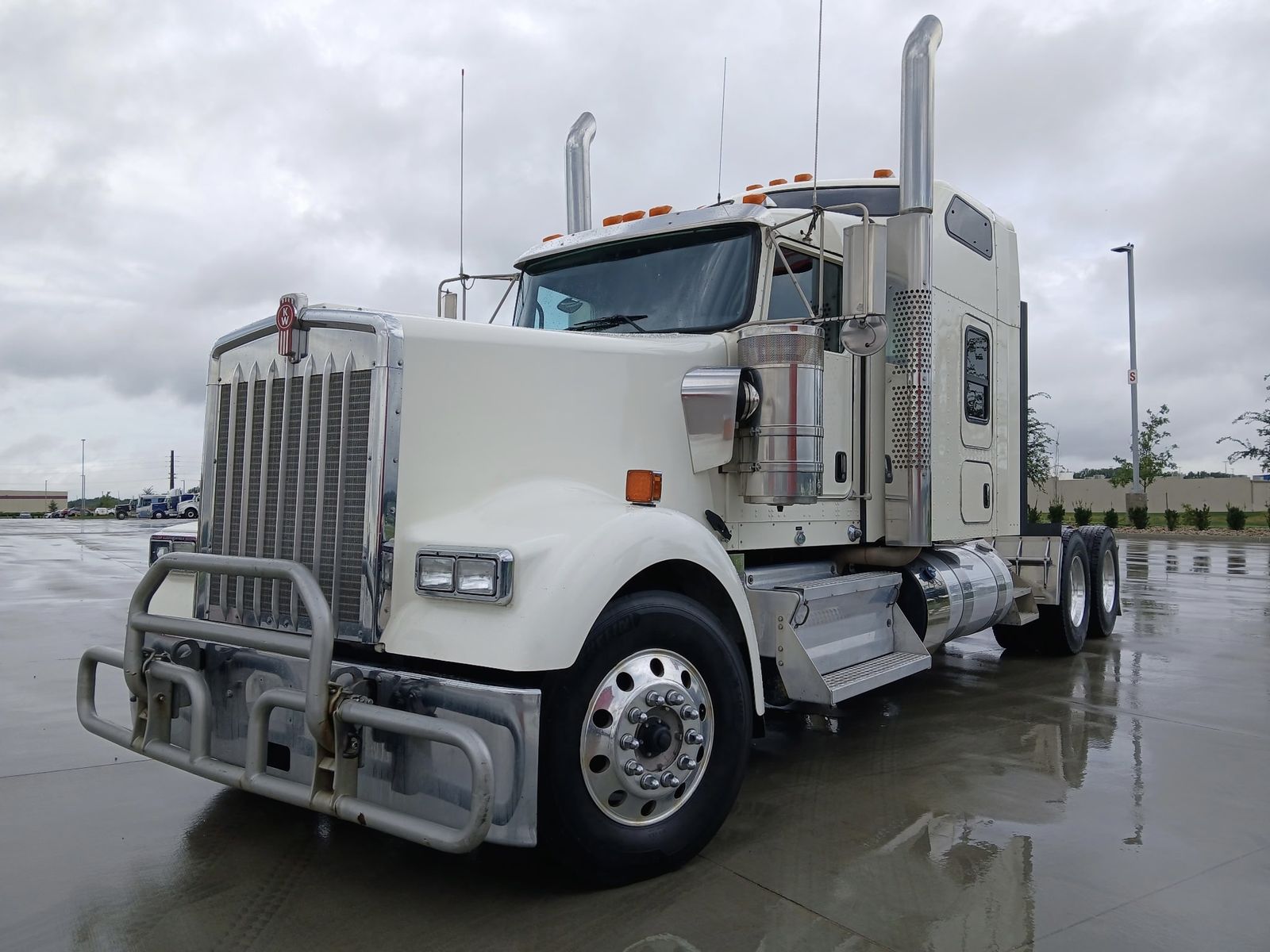 2023 Kenworth W900L 72" Raised Roof Sleeper, front 3/4 driver side